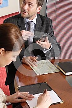 Business man and woman talking in the office