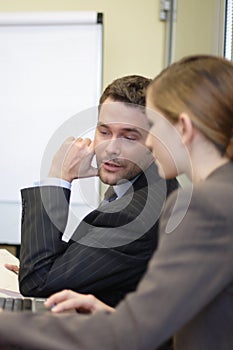 Business man and woman talking in the office