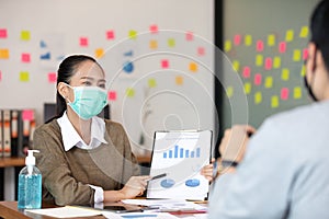 Business man and woman wearing face mask meeting and working together for discussion and brainstrom to get ideas photo