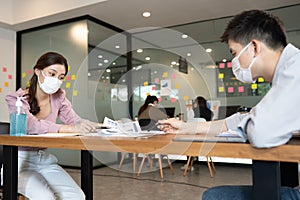 Business man and woman wearing face mask meeting and working together for discussion and brainstrom to get ideas photo