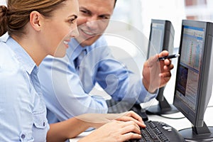 Business man and woman working on computers