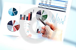 Business man working and analyzing financial figures on a graphs.