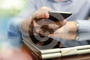 Business man working and analyzing financial figures on a graphs using laptop and mobile phone