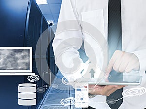 Business man working in data center with tablet device
