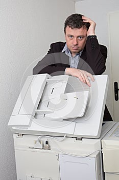 Business man working in front of printer at office