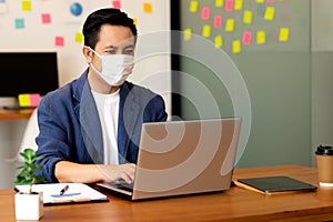 Business man working job on labtop and wering mask