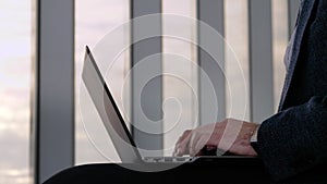 Business man working on laptop at the airport.