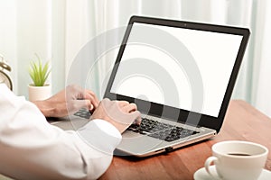 Business man working on laptop computer at home while sitting the wooden table.Male hands typing on the notebook keyboard.Online