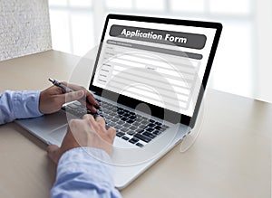 business man working on laptop computer use Online Web Job Application Form moniter photo