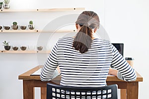 Business man working on a laptop tablet and graph data documents on his desk in home office