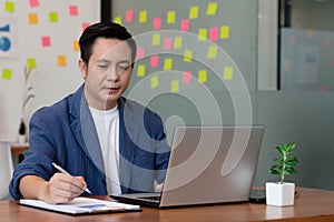 Business man working and note job in paper in office
