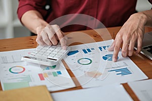 Business man working at office with digital tablet and laptop computer calculating financial report graph data documents