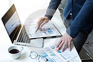 Business man working at office with laptop and documents on his