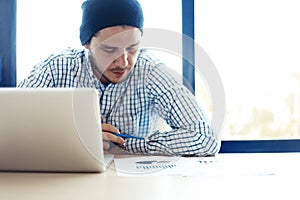 Business man working at office with laptop and documents on his desk