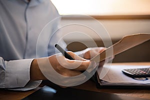 Business man working at office with laptop and documents on his desk, financial adviser analyzing data