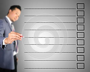 Business man writing on blank checklist