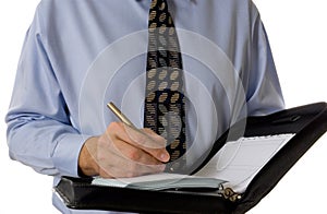 Business man writing in leather organizer