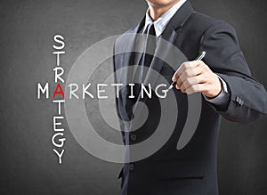 Business man writing marketing strategy concept