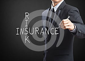 Business man writing Risk Insurance