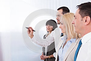 Business man writing on white board