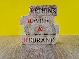Business management branding concept of rethink revise and rebrand words on brick blocks.