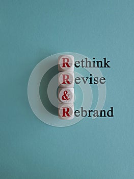 Business management branding concept of rethink revise and rebrand words on wooden cubes.