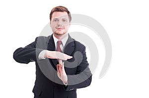 Business manager or businessman showing timeout gesture