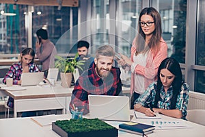 Business manager checking financial task of her colleagues. Smart clever intelligent colleagues discussing the new start up projec