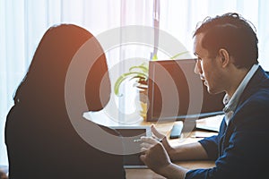 Business manager consulting with female worker