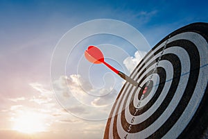 Business marketing as concept. Red dart arrow hitting in the target center of dartboard Target hit in the center