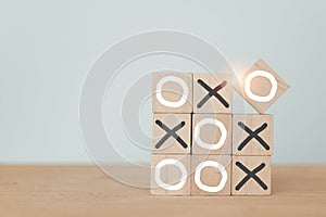 Business marketing strategy planning concept. Wooden block tic tac toe board game including copy space