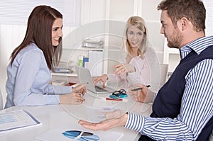 Business meeting: academics and controller sitting around a table.