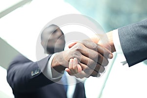 Business meeting. African American businessman shaking hands with caucasian businessman.