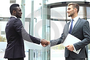 Business meeting. African American businessman shaking hands with caucasian businessman.