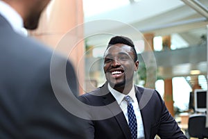 Business meeting. African American businessman shaking hands with caucasian businessman.