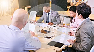 Business meeting between four professional entrepreneurial executives indoors