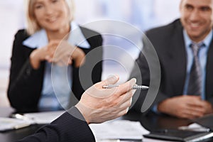 Business meeting, hand with pen in closeup