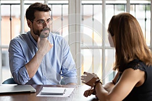 HR manger listening female applicant during job interview photo