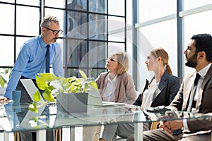 Business meeting - manager discussing work with his colleagues.