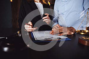 Business - meeting in an office, lawyers or attorneys discussing a document or contract agreement