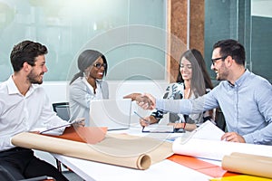 Business meeting at the table and handshake of business partners in a modern office