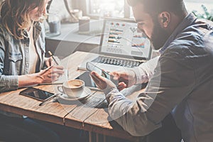 Business meeting. Teamwork. Businessman and businesswoman sitting at table and working.