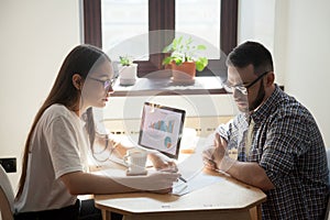 Business meeting: two millennial coworkers solving working quest