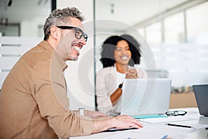 Business meeting where a male professional laughs wholeheartedly photo