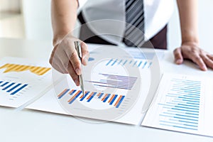 Business men analyze financial graphs and find break-even points for investments in order to reduce costs and reduce corporate tax