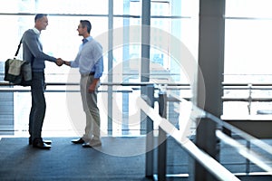 Business men, handshake and partnership deal in hotel lobby, modern office or airport lounge in CRM team meeting