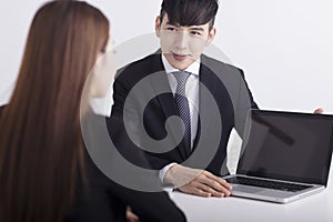 Business men are introducing or consulting businesses to female employees with laptop