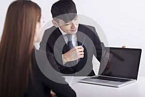 Business men are introducing or consulting businesses to female employees with laptop