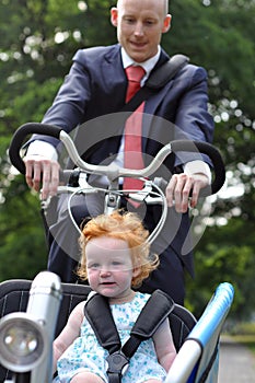 Business men riding his young child to creche photo