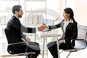 Business men Shaking Hands and Smiling with business women women after agreeing to work together in office